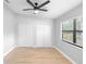 Bedroom featuring ceiling fan, closet and new flooring at 9720 Fairway Cir, Leesburg, FL 34788