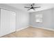 Bedroom featuring ceiling fan, closet and new flooring at 9720 Fairway Cir, Leesburg, FL 34788