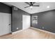 Bedroom features a modern ceiling fan and new flooring at 9720 Fairway Cir, Leesburg, FL 34788