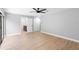 Bright bedroom with wood floors and modern ceiling fan at 9720 Fairway Cir, Leesburg, FL 34788
