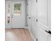 Entryway features white doors, black hardware, and wood-look floors at 9720 Fairway Cir, Leesburg, FL 34788