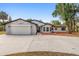 A well-maintained single-Gathering home featuring a two-car garage, front yard, and landscaping at 9720 Fairway Cir, Leesburg, FL 34788