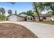 Charming single-story home featuring a two-car garage and nicely manicured front lawn at 9720 Fairway Cir, Leesburg, FL 34788