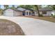 Charming single-story home boasts a manicured lawn, well-lit facade, and attached two-car garage at 9720 Fairway Cir, Leesburg, FL 34788