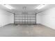 Spacious two car garage with an automatic door and overhead lighting at 9720 Fairway Cir, Leesburg, FL 34788