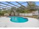 A view of a private screened-in backyard pool with sparkling blue water, patio, and fence at 9720 Fairway Cir, Leesburg, FL 34788