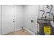 Utility room with a water heater and a door leading to the exterior at 9720 Fairway Cir, Leesburg, FL 34788