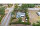 Aerial view showcases the house, its neat yard, and neighborhood streets at 990 W French Ave, Orange City, FL 32763