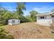 Backyard featuring a shed and plenty of space for activities or gardening at 990 W French Ave, Orange City, FL 32763