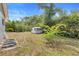 Well maintained backyard with a shed and space for a picnic table under the sun at 990 W French Ave, Orange City, FL 32763