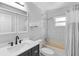 A neutral bathroom featuring a shower-tub combo and a dark sink cabinet at 990 W French Ave, Orange City, FL 32763