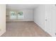 Bright bedroom with neutral carpeting, a window for natural light, and a white door, ready for personalization at 990 W French Ave, Orange City, FL 32763