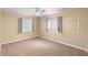 Spacious bedroom with large windows, plush carpeting, and fresh neutral paint at 990 W French Ave, Orange City, FL 32763