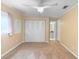Cozy bedroom with a ceiling fan, new carpet, and access to a modern bathroom at 990 W French Ave, Orange City, FL 32763