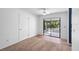 Bedroom featuring sliding glass doors leading to screened patio and carpet at 990 W French Ave, Orange City, FL 32763