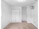 Bright bedroom featuring neutral carpet and a double-door closet for ample storage at 990 W French Ave, Orange City, FL 32763