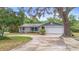Lovely single-story home with a two-car garage, mature landscaping, and a traditional design at 990 W French Ave, Orange City, FL 32763
