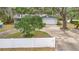 Charming single-story home with a well-maintained lawn, large tree, and a two-car garage at 990 W French Ave, Orange City, FL 32763
