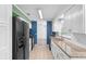 Well-lit kitchen featuring white cabinets, stainless steel appliances, and granite countertops at 990 W French Ave, Orange City, FL 32763