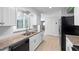 Bright kitchen with white cabinets, granite countertops, and stainless steel appliances at 990 W French Ave, Orange City, FL 32763
