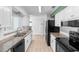 Bright kitchen with white cabinets, granite countertops, stainless steel appliances, and ample counter space at 990 W French Ave, Orange City, FL 32763