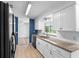 Bright kitchen with white cabinets, granite countertops, and stainless steel appliances at 990 W French Ave, Orange City, FL 32763