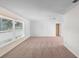 Bright living room with plush carpeting, neutral walls, and a large window offering plenty of natural light at 990 W French Ave, Orange City, FL 32763