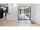 Bright living room with sliding glass doors leading to a screened porch and views of the kitchen at 990 W French Ave, Orange City, FL 32763