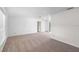 Spacious living room with plush carpeting, neutral walls, and access to other rooms, ready for furnishings at 990 W French Ave, Orange City, FL 32763