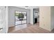 Spacious living area with hardwood-style floors and sliding glass doors, seamlessly connecting indoor and outdoor spaces at 990 W French Ave, Orange City, FL 32763
