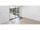 Room featuring sliding glass doors leading to screened patio and wood-look flooring at 990 W French Ave, Orange City, FL 32763