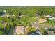 Aerial view of the neighborhood, showcasing a beautiful community and lush landscaping and mature trees at 1120 W Glen Falls Rd, Deland, FL 32720