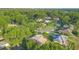 Aerial view of the neighborhood, showcasing a beautiful community and lush landscaping and mature trees at 1120 W Glen Falls Rd, Deland, FL 32720