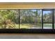 View of the landscaped backyard from the enclosed patio at 1120 W Glen Falls Rd, Deland, FL 32720