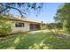 Backyard of home with patio and lush greenery on a sunny day at 1120 W Glen Falls Rd, Deland, FL 32720