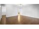 Spacious bedroom with wood floors, ceiling fan, and doors to bathroom and walk-in closet at 1120 W Glen Falls Rd, Deland, FL 32720