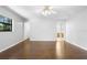 Spacious bedroom with hardwood floors, a ceiling fan, and ensuite bathroom access at 1120 W Glen Falls Rd, Deland, FL 32720