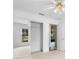 Bedroom with neutral carpet, window, and mirrored closet doors at 1120 W Glen Falls Rd, Deland, FL 32720
