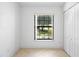 Bright bedroom featuring a large window and closet with neutral-colored tiled floor at 1120 W Glen Falls Rd, Deland, FL 32720