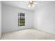Bedroom featuring a window, neutral carpet, and a ceiling fan at 1120 W Glen Falls Rd, Deland, FL 32720
