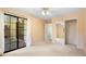Bedroom with sliding glass doors, neutral carpet and mirrored closet doors at 1120 W Glen Falls Rd, Deland, FL 32720