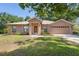 Charming single-story brick home with a well-manicured lawn and attached two car garage at 1120 W Glen Falls Rd, Deland, FL 32720