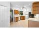 Bright kitchen features wooden cabinets, white appliances, and a view to the living room at 1120 W Glen Falls Rd, Deland, FL 32720