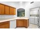 Bright kitchen featuring wood cabinets, white countertops, and a utility area with appliances at 1120 W Glen Falls Rd, Deland, FL 32720