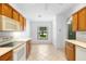 Eat-in kitchen area with neutral tile flooring, a window, and plenty of cabinet space at 1120 W Glen Falls Rd, Deland, FL 32720