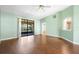 A spacious living room featuring laminate wood flooring, ceiling fan, and pass-through to kitchen at 1120 W Glen Falls Rd, Deland, FL 32720