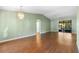Open-concept living area with beautiful laminate floors, ceiling fan and sliding glass doors to the backyard at 1120 W Glen Falls Rd, Deland, FL 32720