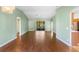 Bright living room with high ceilings, hardwood floors, and a sliding glass door to the lanai at 1120 W Glen Falls Rd, Deland, FL 32720