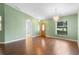 Open living room with hardwood floors and a view to the entrance door at 1120 W Glen Falls Rd, Deland, FL 32720