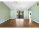 Bright living room with sliding glass doors to the lanai and hardwood floors at 1120 W Glen Falls Rd, Deland, FL 32720